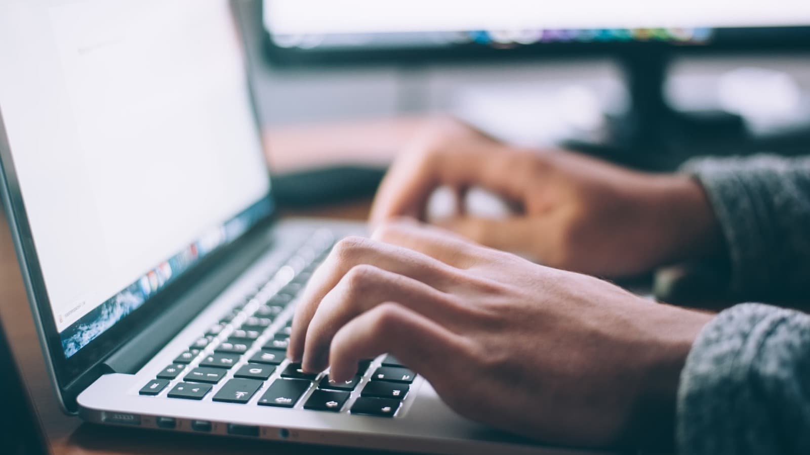 A developer working through code on a laptop