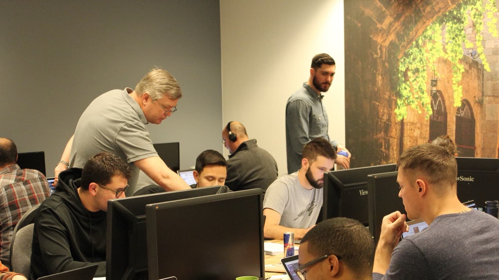 Skill Distillery students coding together with an instructor in the classroom